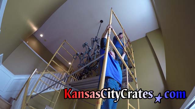 Crate builders assemble scaffolding sections in foyer of home in Overland Park KS