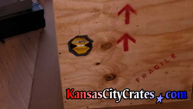 Job site photo of impact indicators affixed to crates that monitor handling while in the chain of custody during transit.