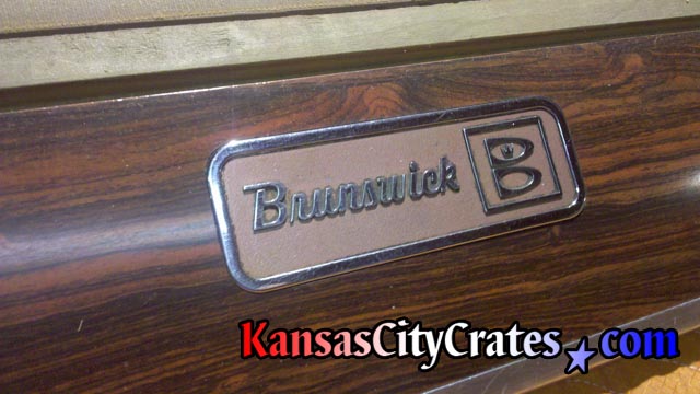 CIrca 1950s Brunswick logo on billiard table rail.