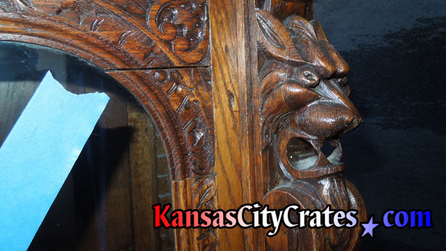 Close up view of lion head hand carved into antique furniture.