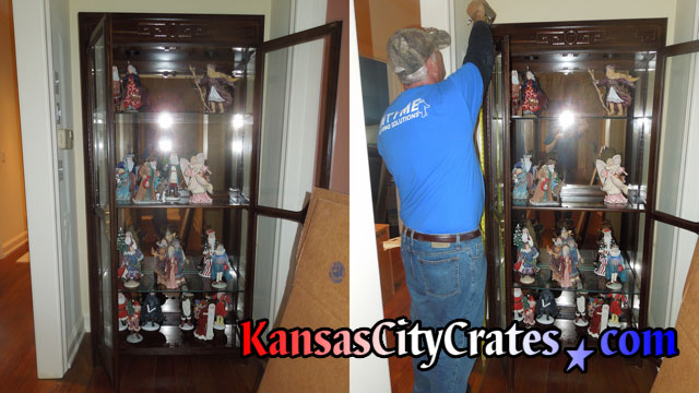 Original glass in antique china cabinet being measured for crating.