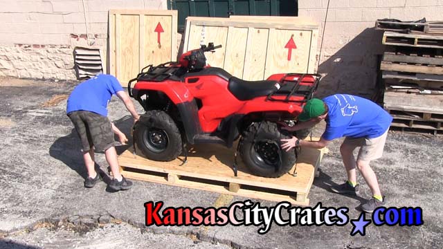 All 4 tires on ATV are secured to pallet by crate staff