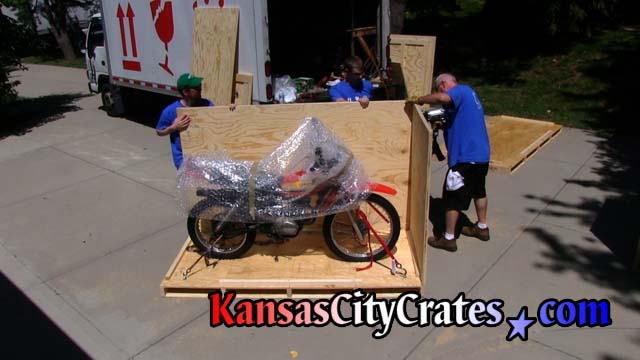 Crater fastens side wall of crate to pallet before shipping 1979 Honda XL 125S  to Canada