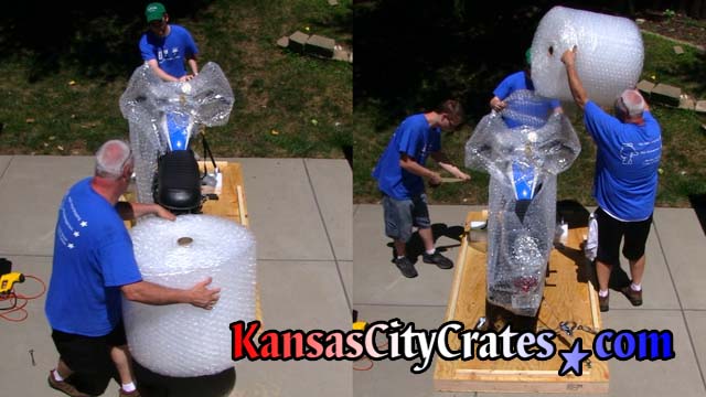 Crate builders bubble wrap motorcycle model that was made famous in the Steve McQueen movie The Great Escape