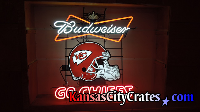 Budweiser neon sign lighted on wall before packing and crating.