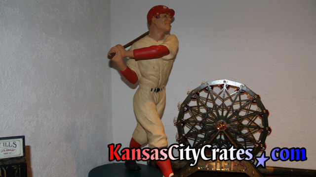 Sculpture of wood baseball player.