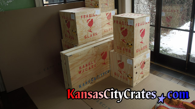 9 solid wall wood crates marked for shipment with Shockwatch impact indicators and content identification labels at home in Overland Park KS  66209