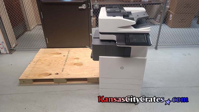 HP WebJet Admin E77830Z printer positioned on solid deck pallet before packaging