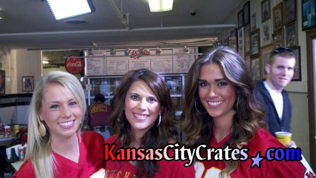 Photo os three Kansas City Chiefs Cheerleads at Bryants BBQ filming television commercial with Rob Riggle photobombed by Army Ranger